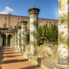 Cloître de Santa Chiara à Naples, avec ses colonnes ornées de majoliques et son banc en céramique.