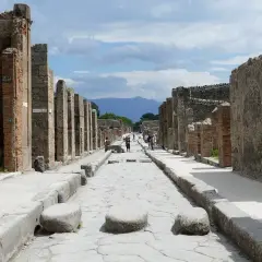 Ruines de Pompéi, une ancienne voie romaine menant vers le Vésuve. Un voyage de Rome à Pompéi est une immersion dans l'histoire.