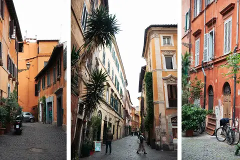 Ruelles étroites et pavées de la ville de Rome, bordées de bâtiments aux façades colorées et ornées de plantes vertes.