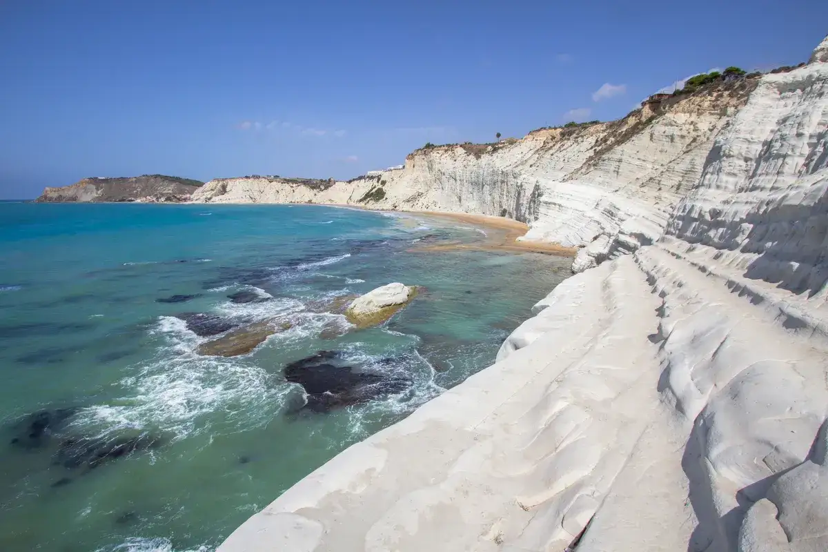 La Scala dei Turchi, une falaise de marne blanche sculptée par la mer, se dresse majestueusement face aux eaux turquoise de la Sicile.