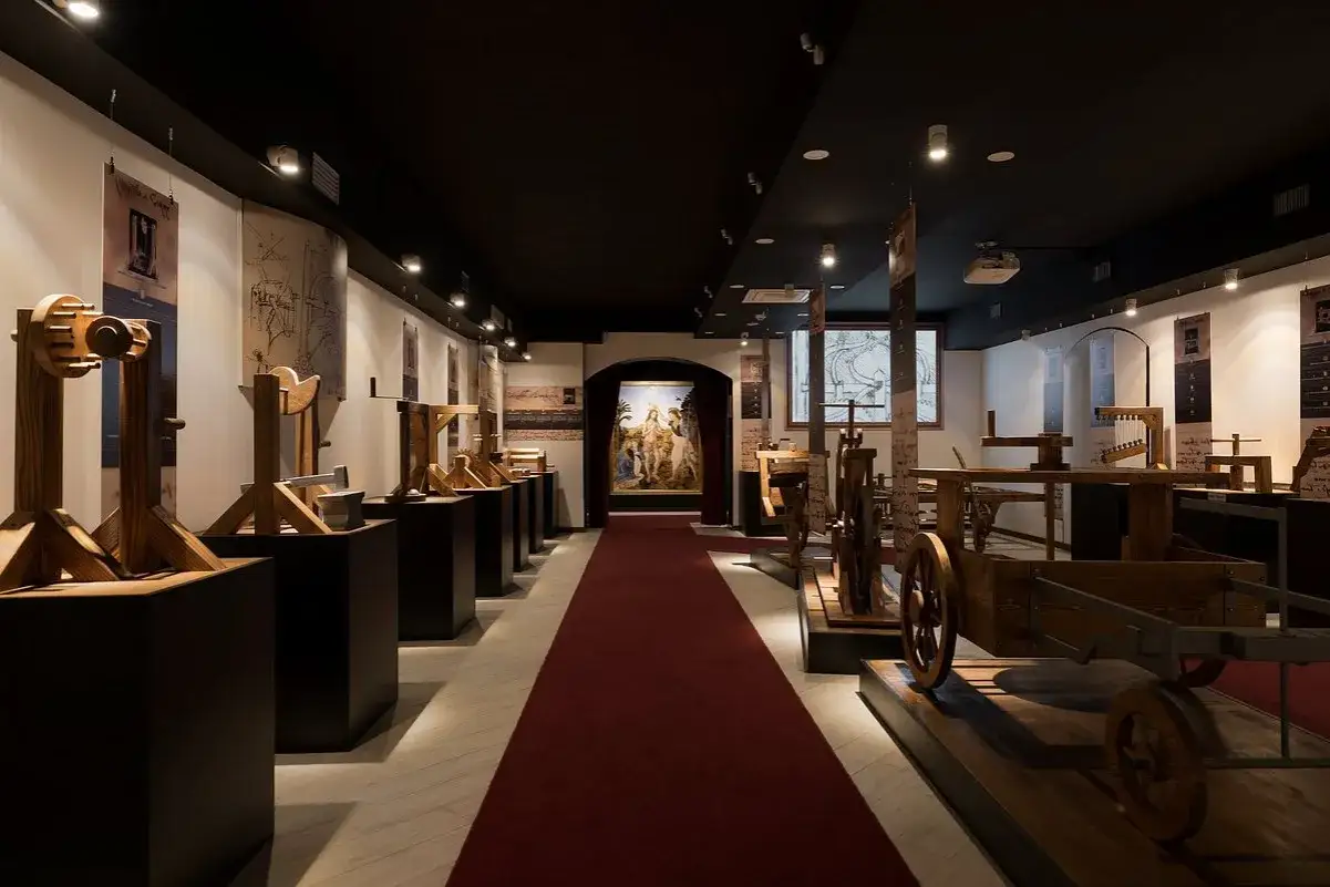Intriguing wooden models of Leonardo da Vinci's inventions fill this museum in Rome. A red carpet leads to a painting.