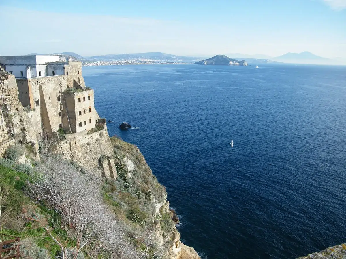 Vue depuis le fort de San Michele à Procida, dominant la mer bleue. Au loin, des îles et le Vésuve.